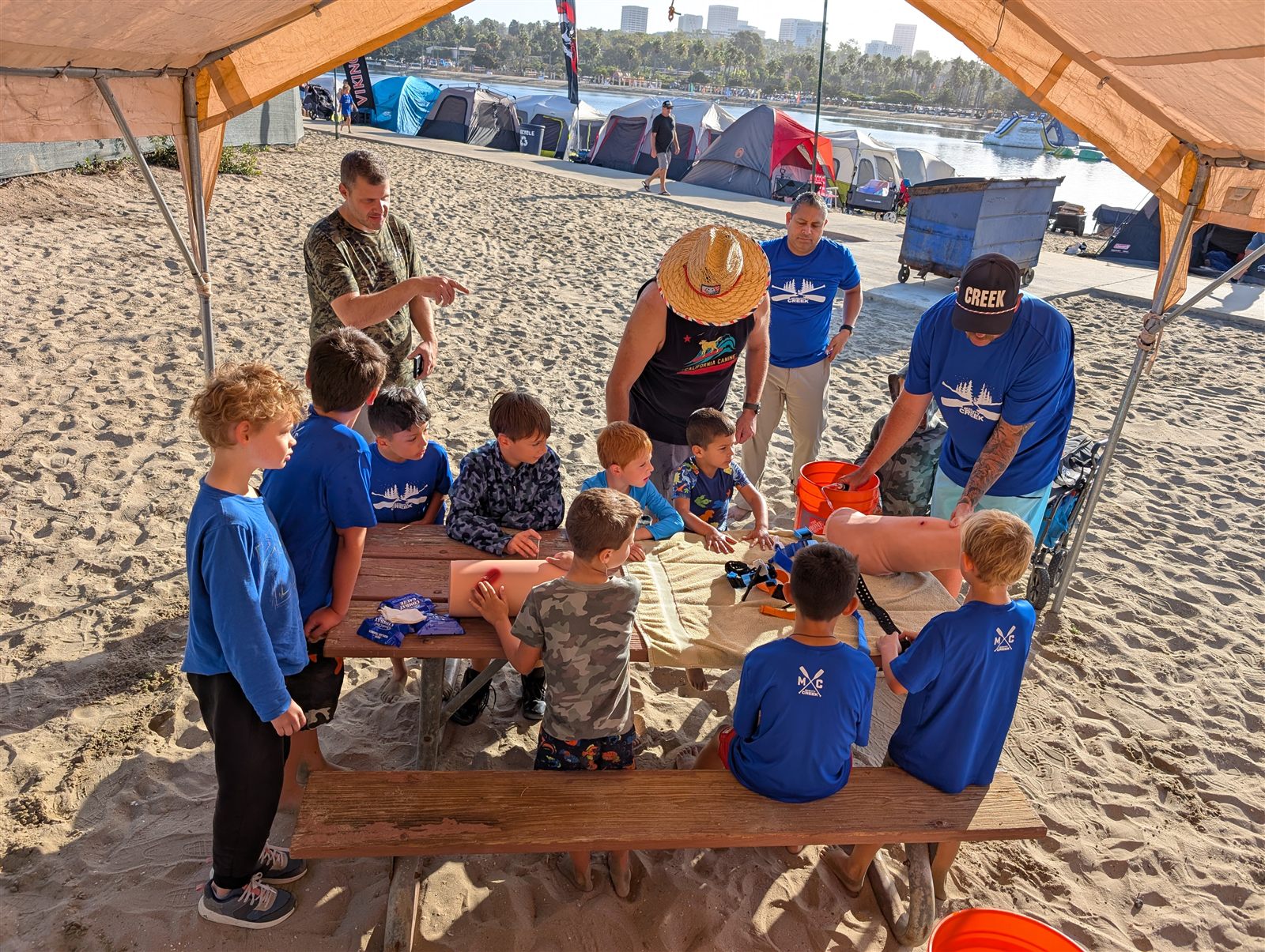 A first-aid demonstration for the circle at a beach campout